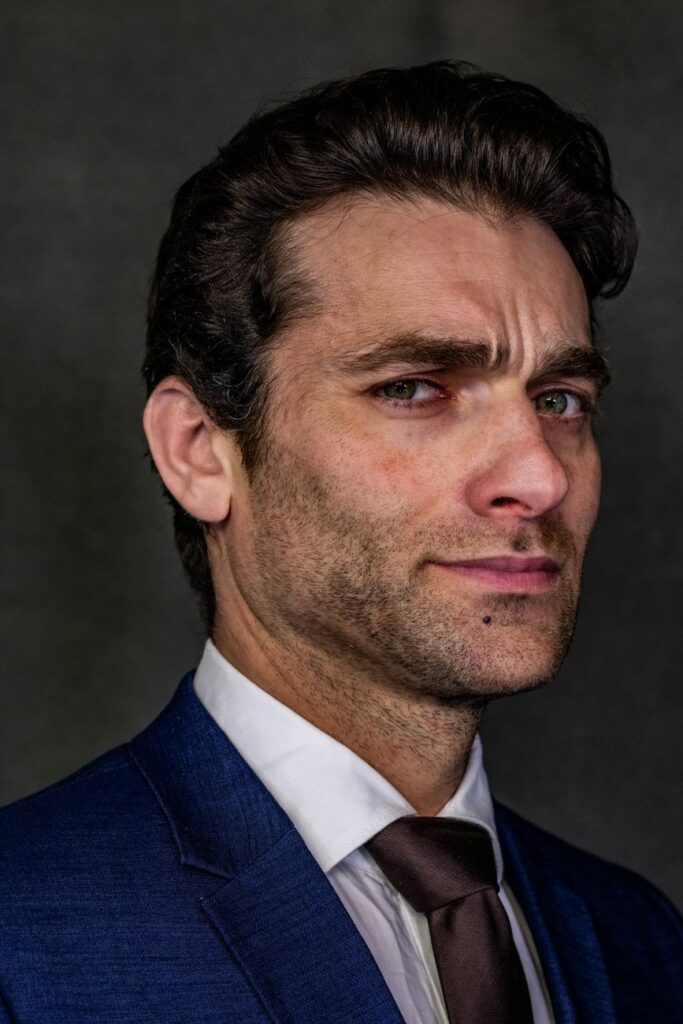 Close-up portrait of a confident businessman wearing a dark suit, exuding professionalism.