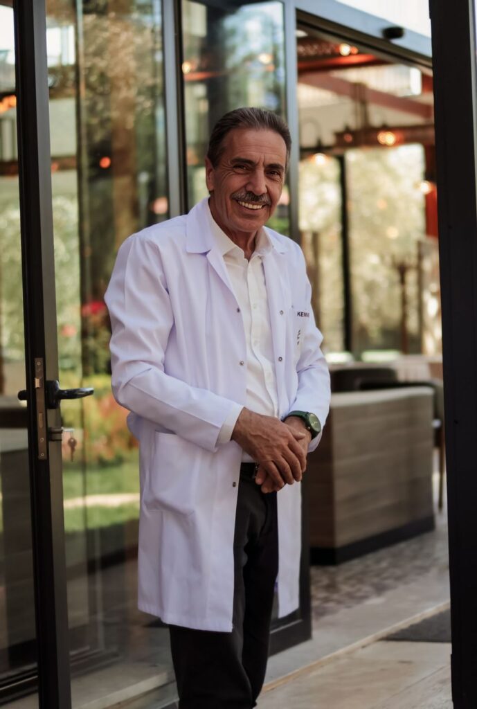 A mature man in a white coat standing outdoors, exuding confidence.